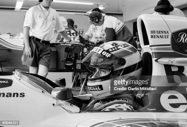 Brazilian race car driver Ayrton Senna sits in a racecar as he prepares for a qualifying round of the San Marino F1 Grand Prix on the Imola Circuit,...