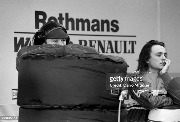 Mechanics from the Williams racing team wait for news about the condition of Formula 1 driver Ayrton Senna, after his accident during the San Marino...