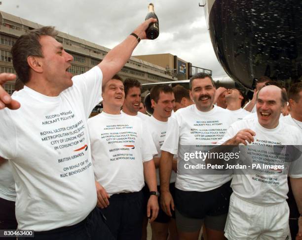 Royal Ulster Constabulary Chief Contstable Sir Ronnie Flanagan is sprayed with champagne to celebrate after he joined sixty police officers from the...