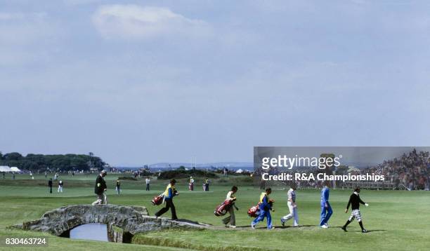 Players cross the Swilken Bridge during the 1978 Open Championship at St Andrews.