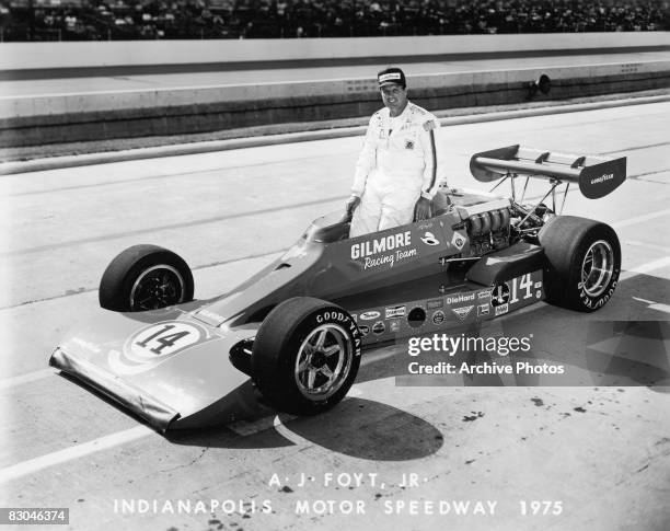 American professional race car driver A. J. Foyt Jr. Standing in the cockpit of his car at Indianapolis Motor Speedway, Indianapolis, Indiana, 1975.