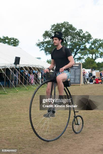 Guest rides a Penny Farthingon day 3 of Wilderness Festival on August 5, 2017 in Cornbury Park, Oxford, England.