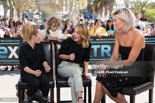 The doll from the film "Annabelle" surprises Lulu Wilson, Talitha Bateman and Charissa Thompson at "Extra" at Universal Studios Hollywood on August...