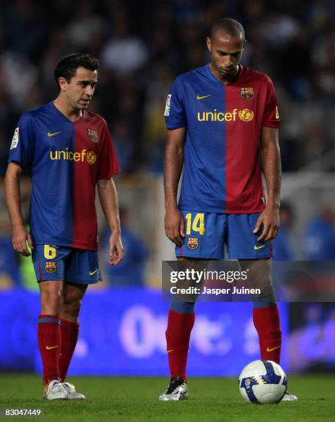Thierry Henry of Barcelona concentrates on taking a free kick flanked by his teammate Xavier Hernandez during the La Liga match between Espanyol and...