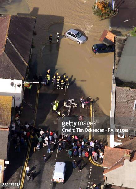 Members of the fire service help locals in central Uckfield, that was flooded after 14cm of rain fell overnight in the Kent and Sussex areas. *......
