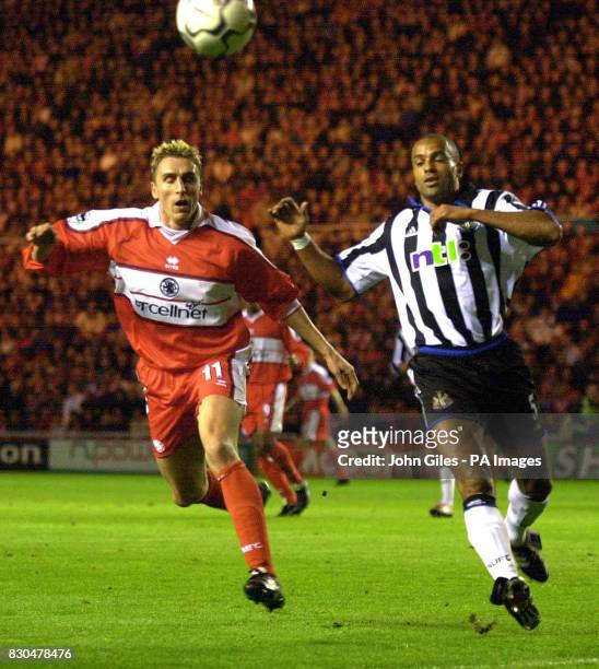 Alen Boksic of Middlesbrough is just beaten by Alain Goma of Newcastle United to this cross during their FA Premiership football match at the...