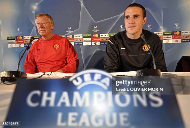 Manchester United's manager Sir Alex Ferguson and defender John O'Shea attend a press conference on september 29, 2008 prior to a training session in...