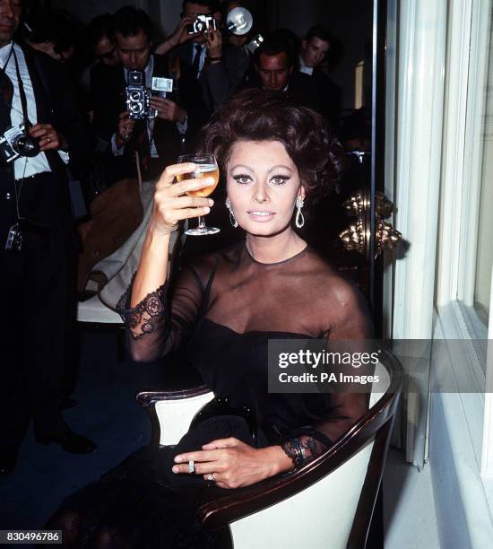 Italian actress Sophia Loren poses for photographers at the Savoy Hotel in London. Sophia is here for talks with Charlie Chaplin, who is to direct...