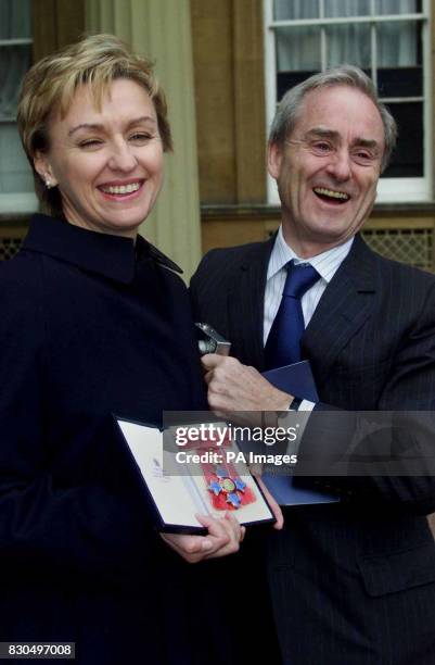 British magazine editor Tina Brown with her husband Harold Evans, after she received her CBE from British Queen Elizabeth II at Buckingham Palace in...