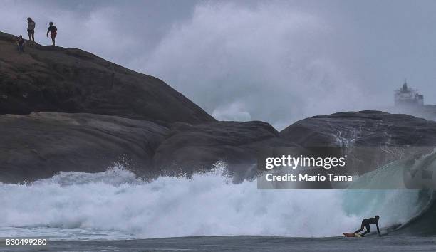 Surfer catches a wave during strong winter swells on the Atlantic Ocean on August 11, 2017 in Rio de Janeiro, Brazil. Waves were measured as high as...