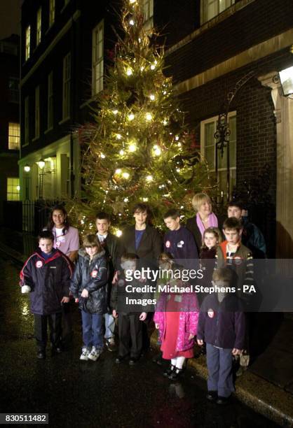 Woman's Own Children of Courage 2000 help British Prime Minister Tony Blair's wife Cherie turn on the Downing Street lights, in London, with her...
