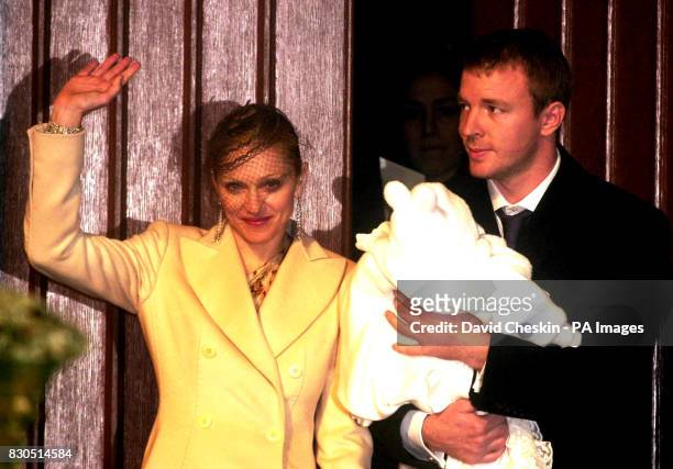 Pop star Madonna and partner Guy Ritchie leave Dornoch Cathedral after having their baby Rocco Christened. She was wearing a cream full length coat...
