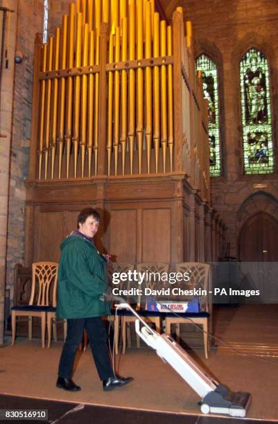 Reverend Susan Brown cleans up after the christening yesterday of Madonna and Guy Ritchie's baby Rocco at Dornoch Cathedral. Rev Susan Brown will...