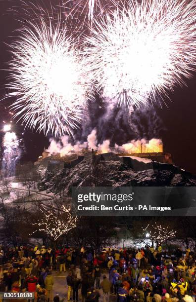 Hogmanay revellers watch the fireworks light up the night sky over Edinburgh Castle in Scotland as New Year 2001 comes in. * : Edinburgh Castle, one...