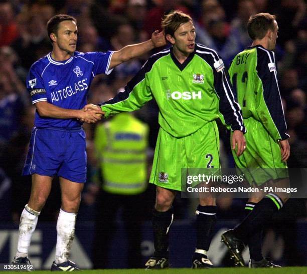 Chelsea's Dennis Wise shakes hands with Peterborough United's Dean Hooper after their FA Cup Third round match at Stamford Bridge, London. Final...