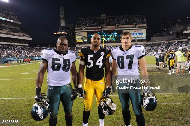 Defensive end Trent Cole and tight end Brent Celek of the Philadelphia Eagles pose for a photo with linebacker Andre Frazier of the Pittsburgh...