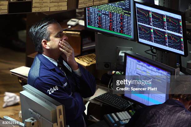 Trader rubs his face as he works on the floor of the New York Stock Exchange September 29, 2008 in New York City. U.S. Stocks took a nosedive in...