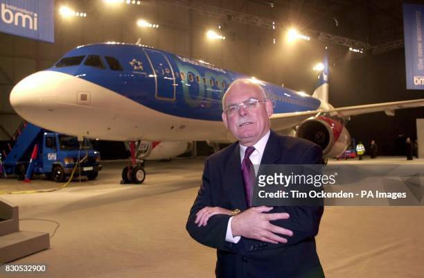 Chairman of British Midland Sir Michael Bishop Chairman stands in front of a plane with the company's new corporate identity at Heathrow in London ....