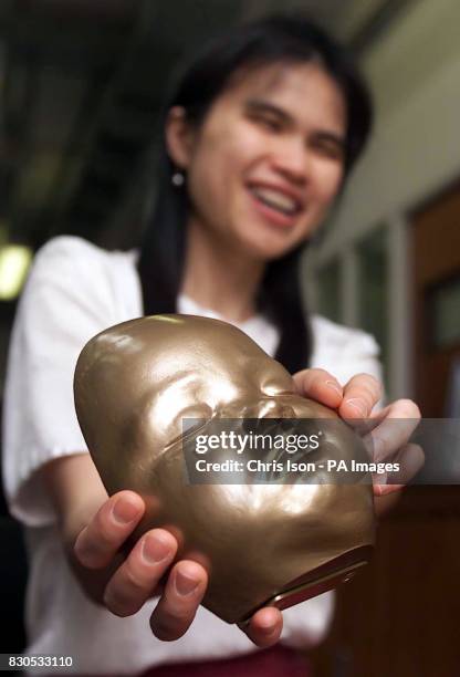 Yuen Har Tse with a model of her son Christopher's face aged 7 months. Engineers at Exeter University's Advanced Technologies Dept made the polymer...