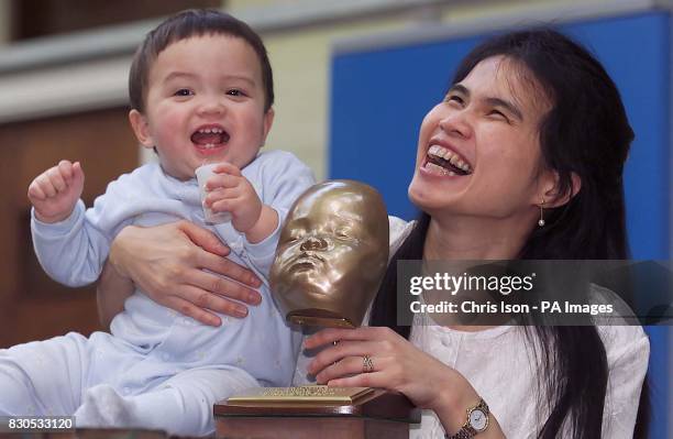 Yuen Har Tse with her 12 month son Christopher and a model of his face aged 7 months. Engineers at Exeter University's Advanced Technologies Dept...