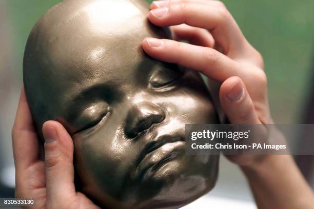 Yuen Har Tse with a model of her son Christopher's face aged 7 months. Engineers at Exeter University's Advanced Technologies Dept made the polymer...