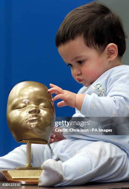 Yuen Har Tse's son Christopher with a model of his face aged 7 months. Engineers at Exeter University's Advanced Technologies Dept made the polymer...