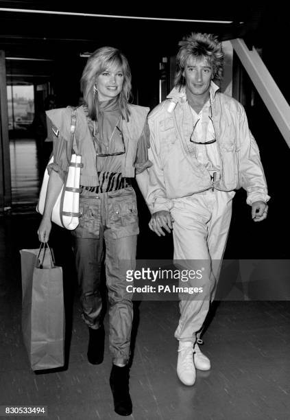Rod Stewart and his girlfriend Kelly Emberg on arriving at Heathrow airport from Los Angeles.