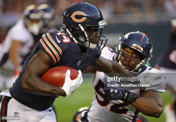 Deonte Thompson of the Chicago Bears fights off a tackle attempt by Corey Nelson of the Denver Broncos during a preseason game at Soldier Field on...