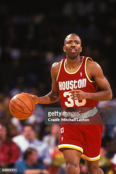 Kenny Smith of the Houston Rockets dribbles up court during a NBA basketball game against the Washington Bullets at USAir Arena on February 17, 1995...