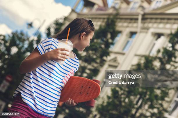 teenage girl with skateboard in urban environment - calcio sport imagens e fotografias de stock