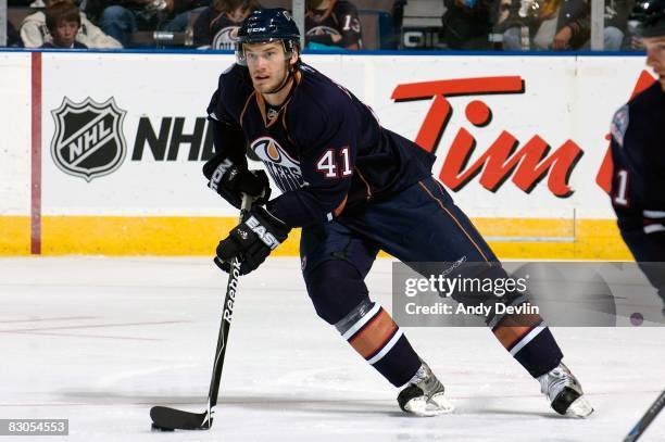 Taylor Chorney of the Edmonton Oilers carries the puck during a preseason game against the Florida Panthers on September 25, 2008 at Rexall Place in...