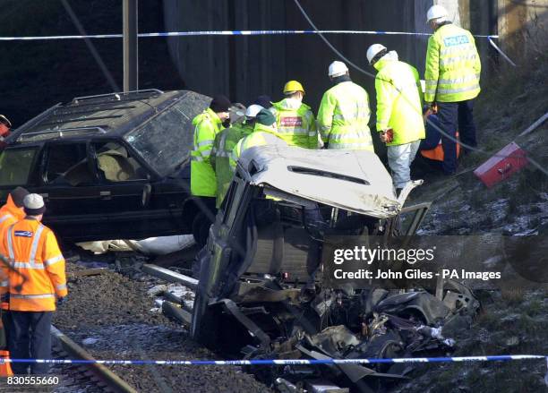 Police examine the wreckage of the Land Rover and the car it was towing at the scene of the horrific crash that killed 13 people in Selby North...