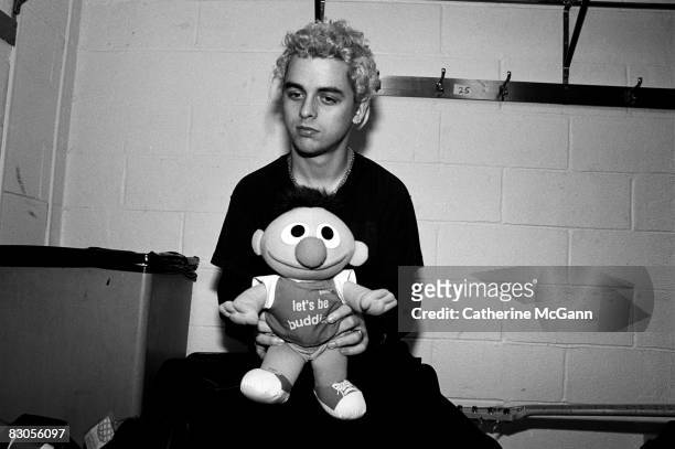 Billie Joe Armstrong of Green Day poses for a portrait holding a stuffed doll of Ernie from "Sesame Street" printed with the words "Let's Be Buddies"...