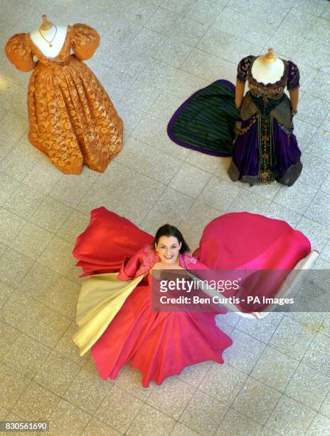 Model Eve Armstrong, wearing the pink silk taffeta dress as worn by Madonna in the film Evita, in a display of Hollywood costumes as part of the...