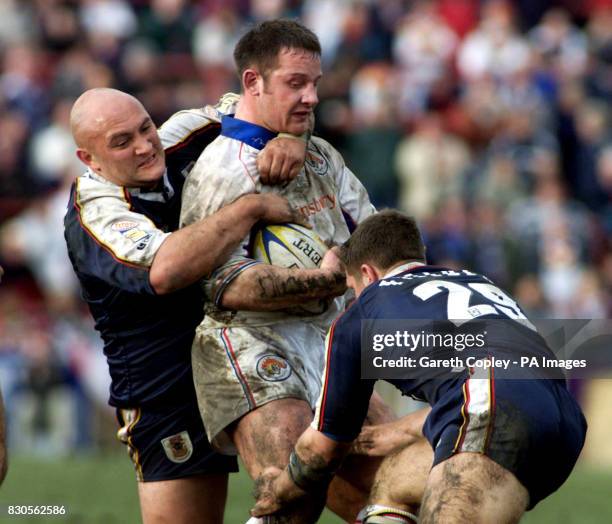 Wakefield Wildcat's Paul Jackson is tackled by Bradford Bull's Paul Anderson and Stuart Fielden during Silk Cut Challenge Cup Quarter Final at Belle...