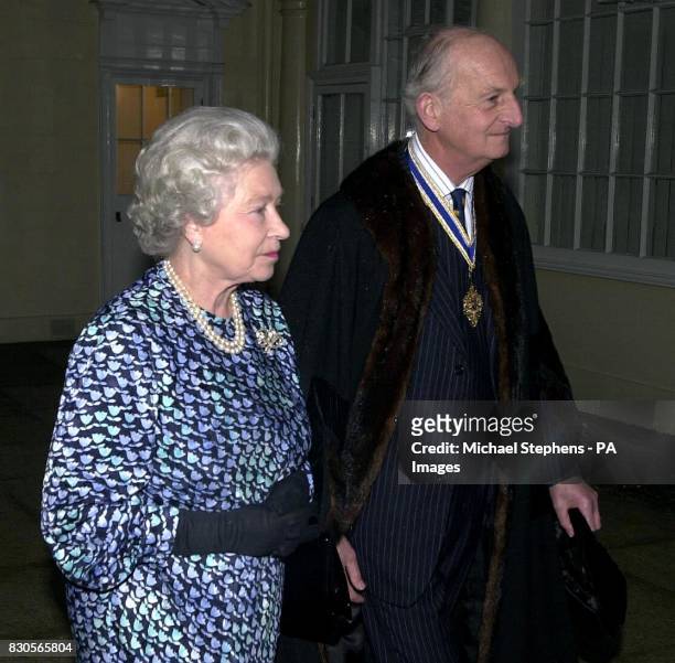 Britain's Queen Elizabeth II accompanied by The Master of The Livery Dr John Briscoe, when she attended a reception at Apothocaries Hall in the City...