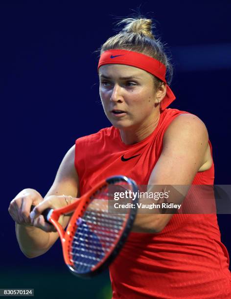 Elina Svitolina of Ukraine plays a shot against Garbine Muguruza of Spain during Day 7 of the Rogers Cup at Aviva Centre on August 11, 2017 in...