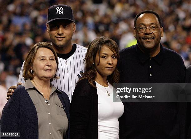 Derek Jeter of the New York Yankees poses with his family, father Charles mother Dorothy and sister Sharlee,during pregame ceremonies prior to the...