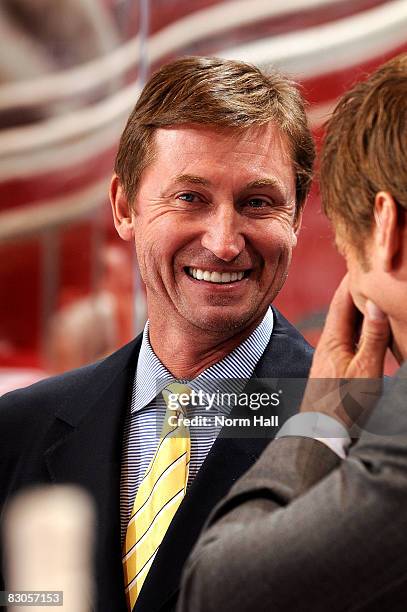 Head Coach Wayne Gretzky smiles from behind the bench as his team takes a 4-1 lead into the third period against the San Jose Sharks on September 29,...