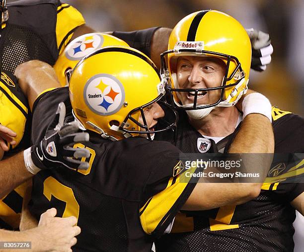 Jeff Reed of the Pittsburgh Steelers celebrates a 23-20 overtime victory over the Baltimore Ravens after his overtime field goal with Mitch Berger on...