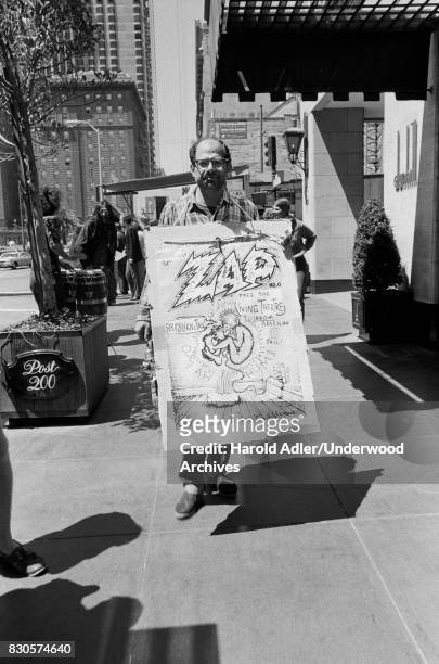 Allen Ginsberg carrying an R Crumb poster while demonstrating at Union Square against the arrests of Living Theater Company members in Brazil, San...