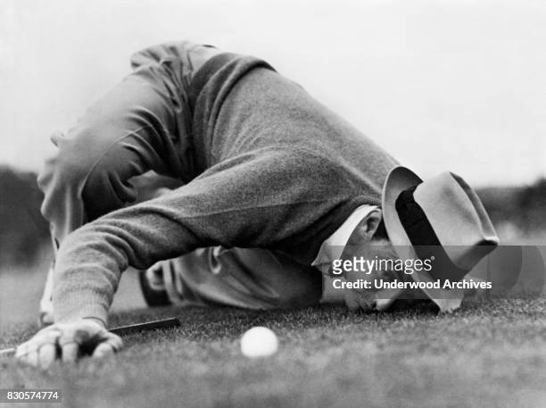 Professional golfer Sam Snead lines up a putt during the Masters Tournament, but lost in the final round to Ralph Guldahl, Augusta, Georgia, 1939.