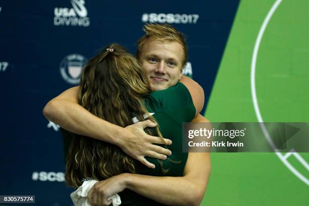 Gregory Duncan of the Dominion Dive Club is congratulated by his coach Stephanie Sutton of the Dominion Dive Club after winning the Senior Men's 3m...