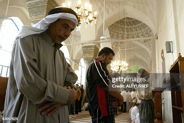 Iraqi Sunni Muslim men perform the Eid Al-Fitr morning prayers at the Sheikh Abdul Qadir al-Jilani mosque in central Baghdad on September 30, 2008....