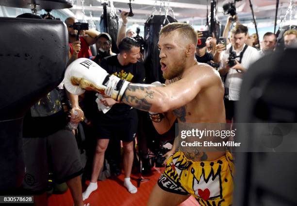 Lightweight champion Conor McGregor hits an uppercut bag during a media workout at the UFC Performance Institute on August 11, 2017 in Las Vegas,...