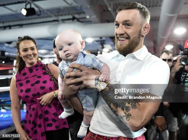 Lightweight champion Conor McGregor carries his son Conor McGregor Junior during a media workout at the UFC Performance Institute on August 11, 2017...
