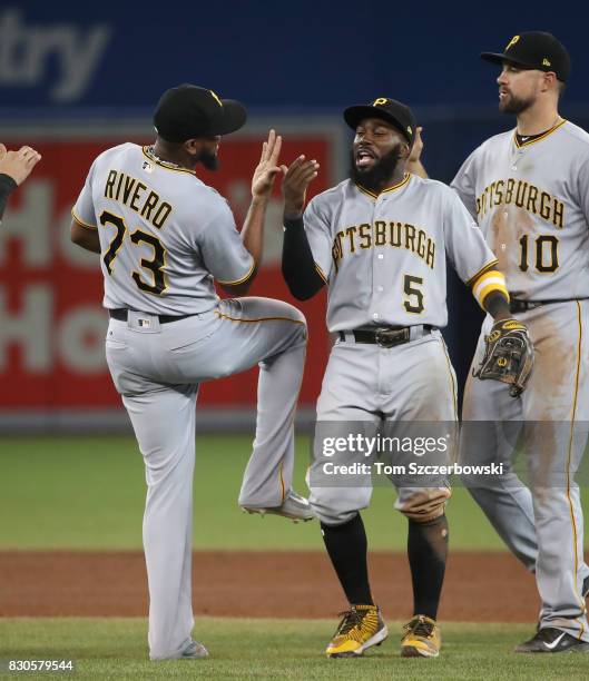 Josh Harrison of the Pittsburgh Pirates celebrates their victory with Felipe Rivero during MLB game action against the Toronto Blue Jays at Rogers...