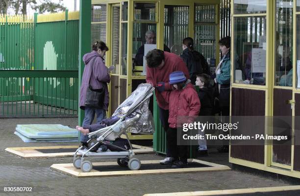 Visitors walk over disinfectant mats at the Whipsnade WIld Animal Park in Bedfordshire Thursday April 19 on the first day it reopened after its...