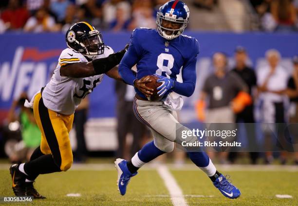 Quarterback Josh Johnson of the New York Giants is chased by Arthur Moats of the Pittsburgh Steelers during the first quarter of an NFL preseason...