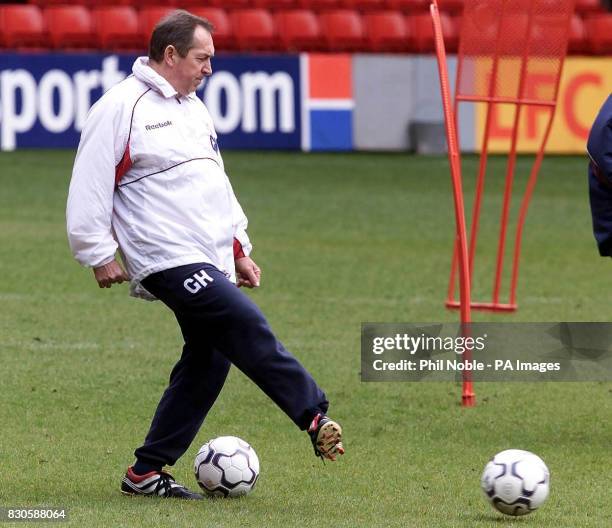 Liverpool manager Gerard Houllier passes a ball during an open training session at Anfield, Liverpool, ahead of their two Cup Finals this month....